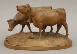 A Blackforest carved model of two cows. 22 cm long.