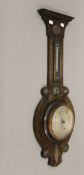 An early 20th century oak barometer and a brass fender. The former 78 cm high.