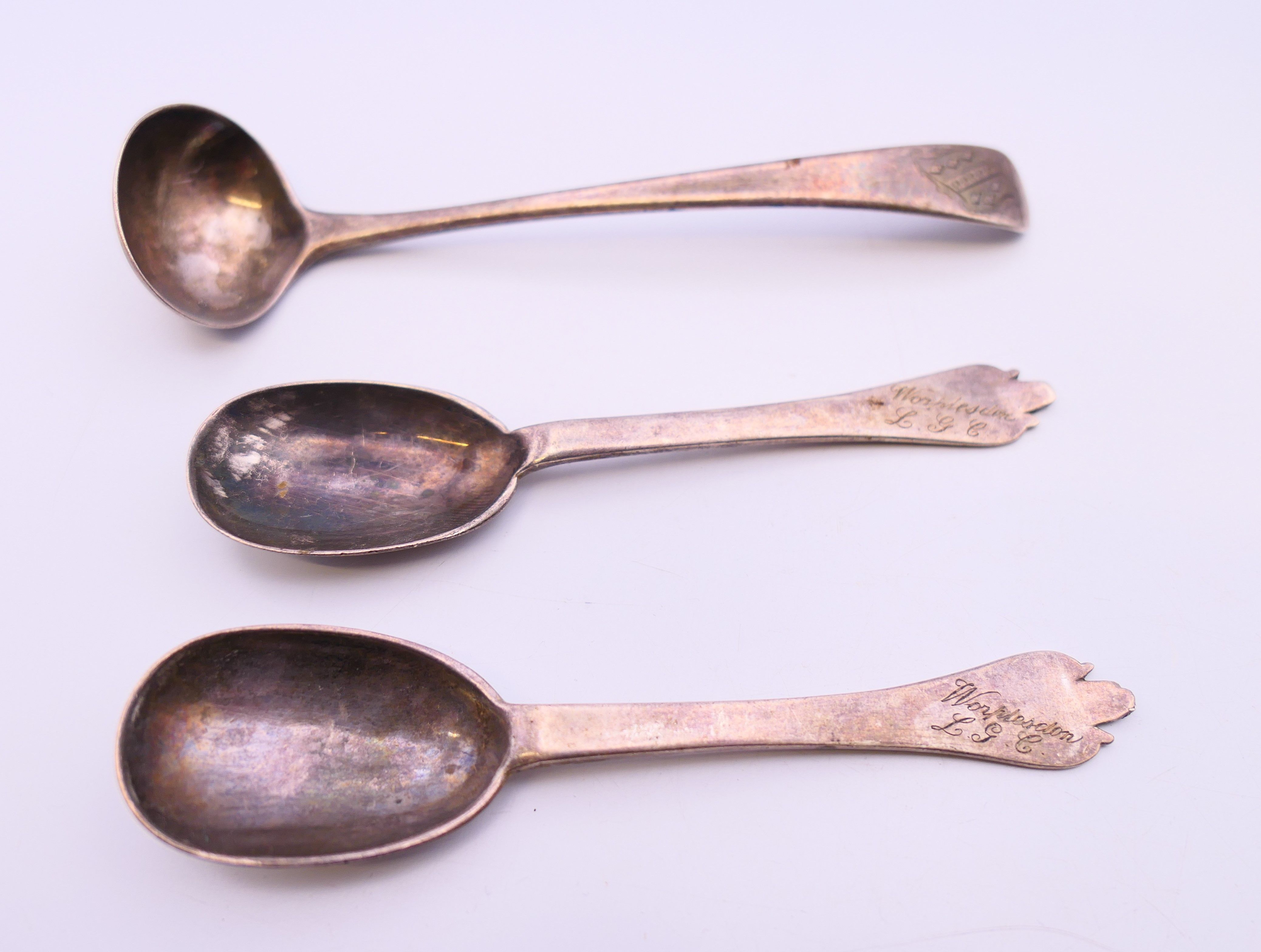 A pair of silver spoons and a small silver ladle. Spoons each 10 cm long. 39.4 grammes.