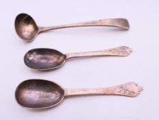 A pair of silver spoons and a small silver ladle. Spoons each 10 cm long. 39.4 grammes.