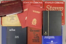 A stamp collection and a cigarette card album.