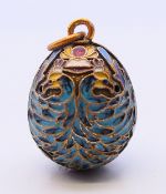 A silver and enamel egg pendant with Russian marks. 2.5 cm high.