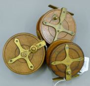 A collection of three wooden Nottingham reels, all with brass starbacks and ratches.