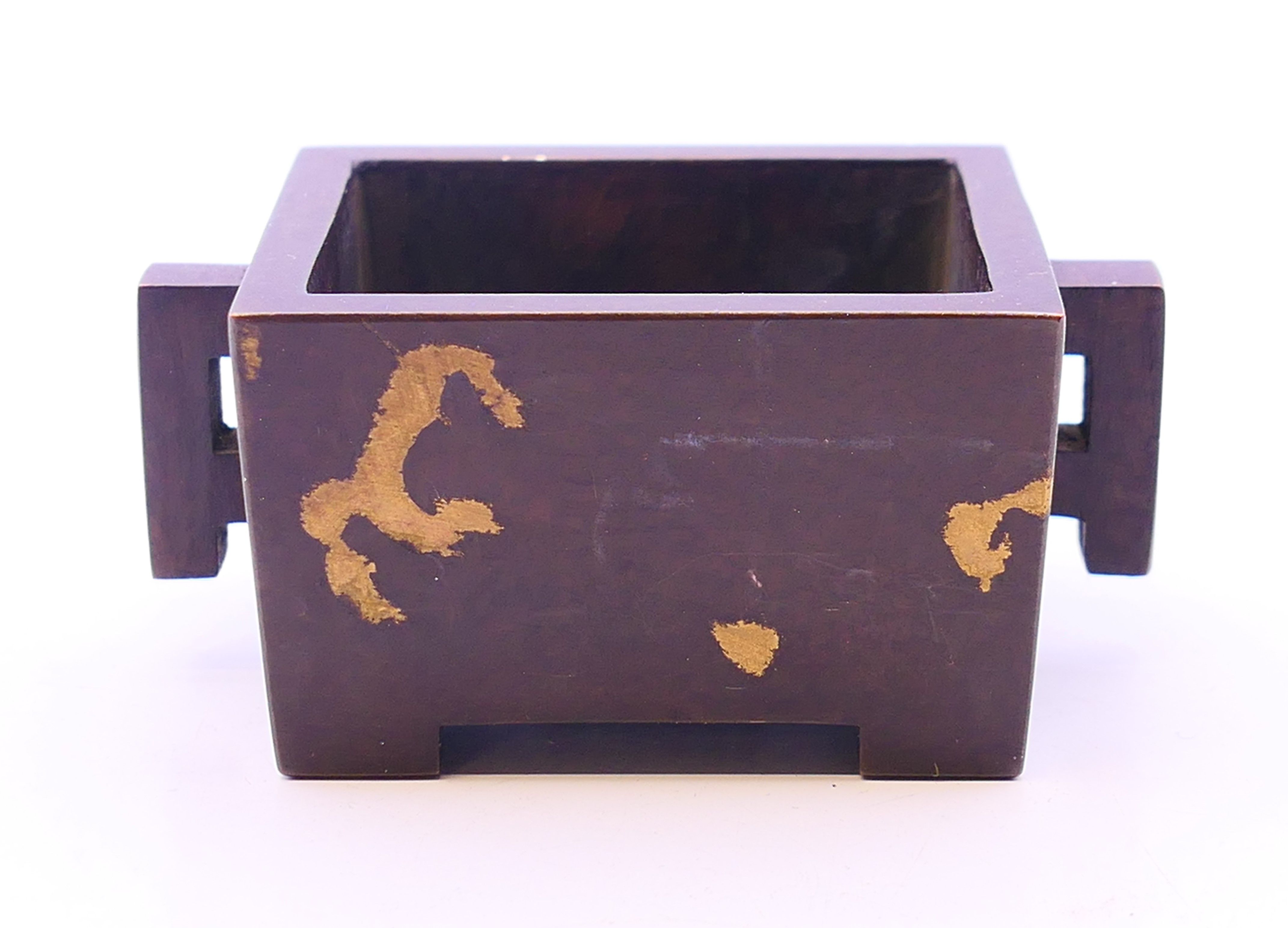 A bronze rectangular gold splash censer. 3 cm high.