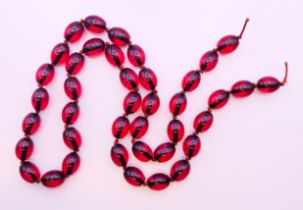 A string of beads. 78 cm long.