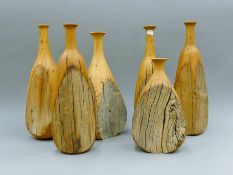 Six carved wooden vases. The largest 42 cm high.