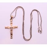 A silver crucifix on a silver chain.