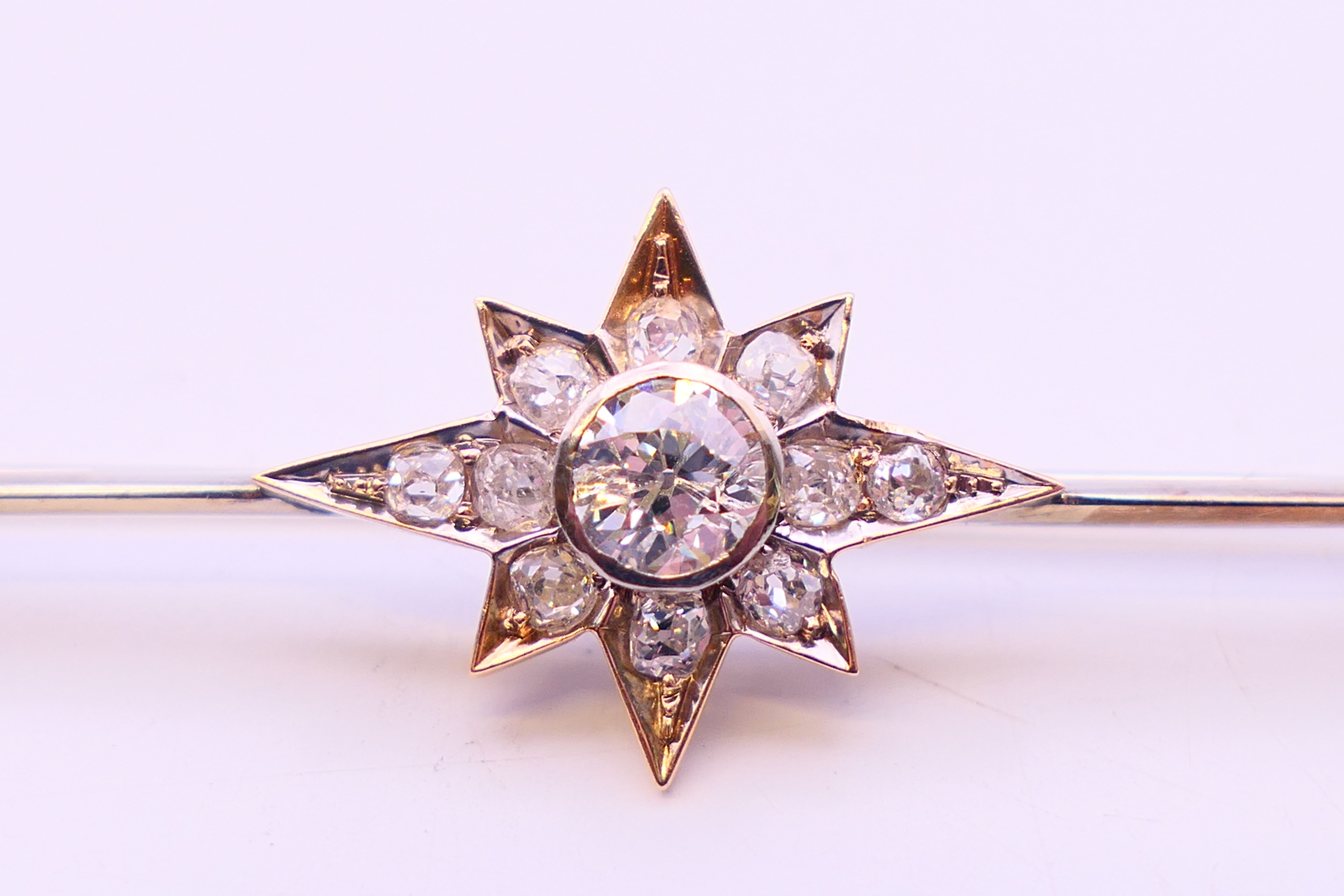 An antique bar brooch with diamond set star design, the central diamond approximately 0.5 carat. - Image 2 of 7
