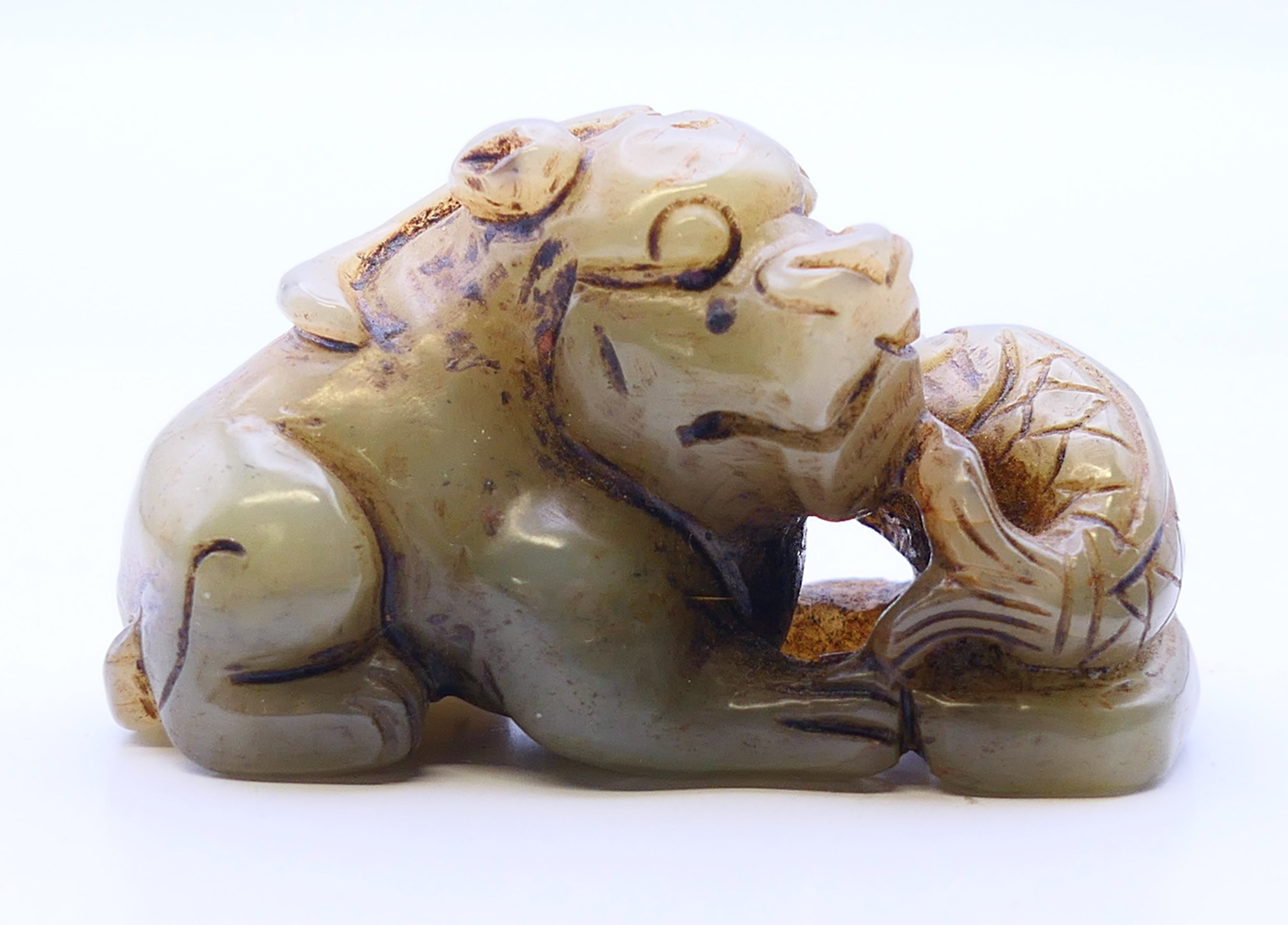 A jade dog-of-fo with a fish. 6 cm wide, 3.5 cm high.