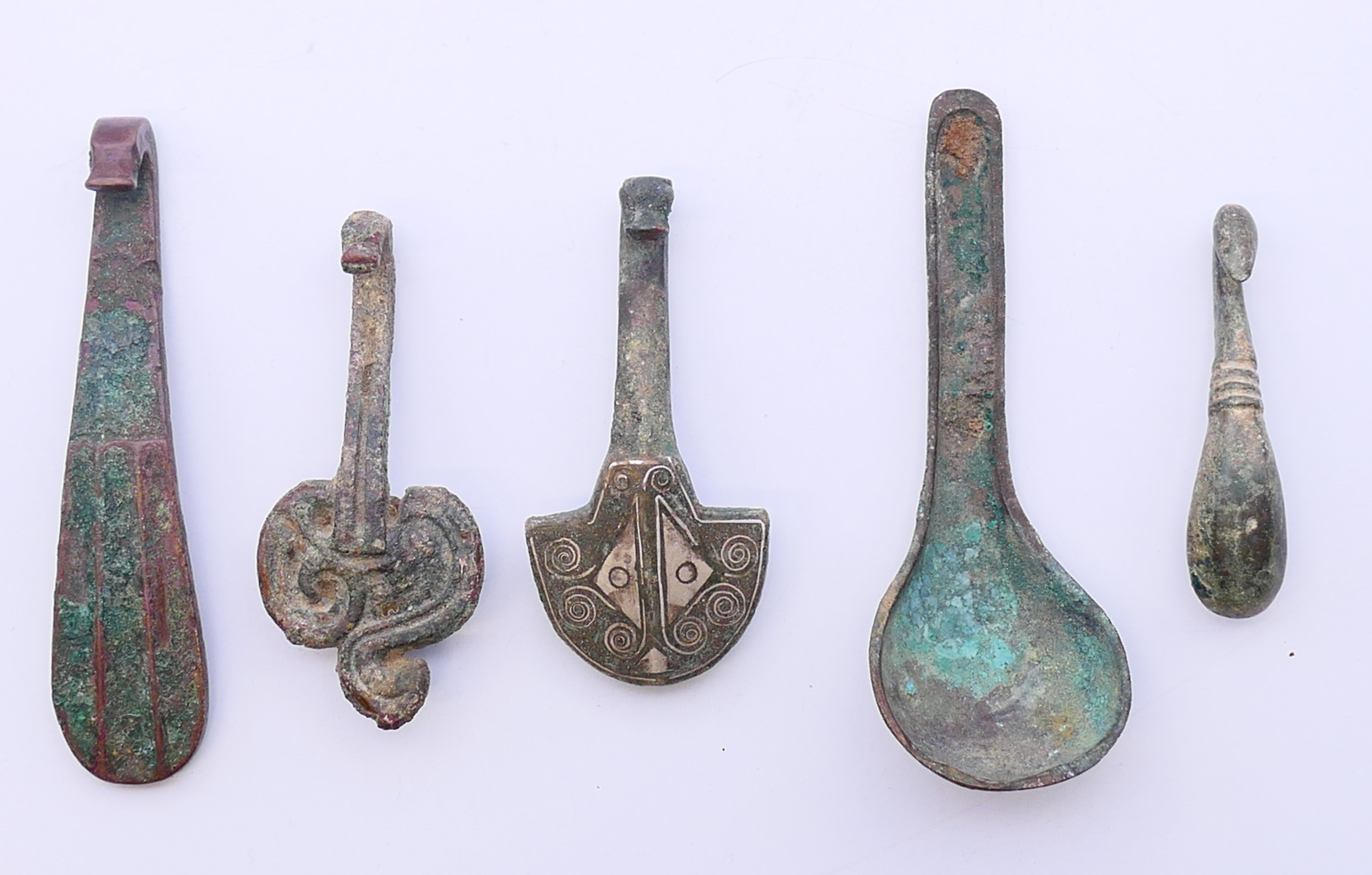 Five various bronze objects. Spoon 9 cm high.