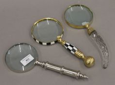 Three assorted magnifying glasses. The largest 26.5 cm long.