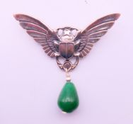 An Art Deco style winged beetle brooch with jade drop. 5 cm high.