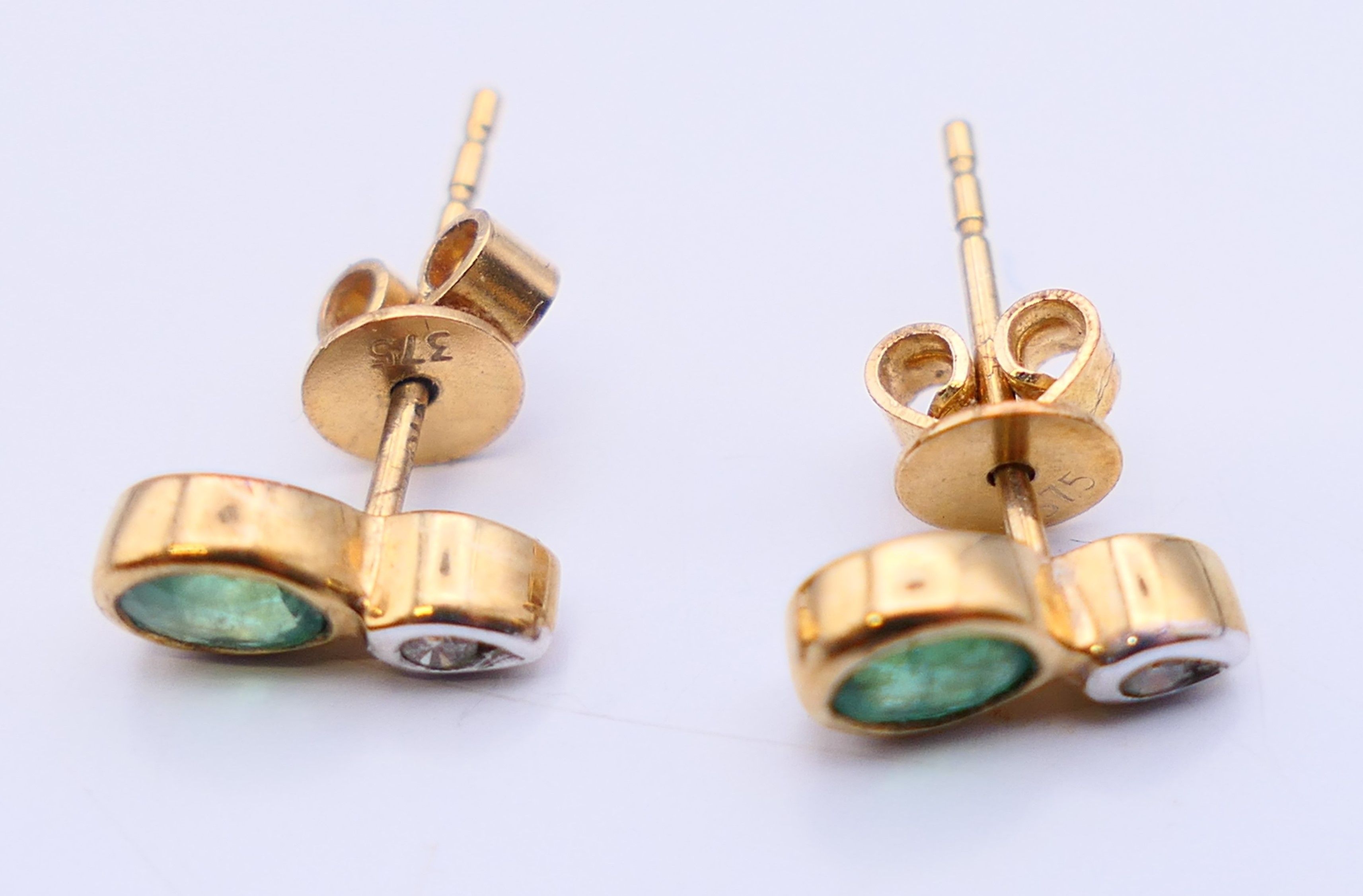 A pair of 9 ct gold earrings set with diamonds and emeralds. 0.75 cm high. - Image 4 of 4