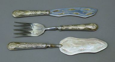 A three-piece white metal fish and cake cutlery set with cast 800 mark. The largest 26.5 cm long.