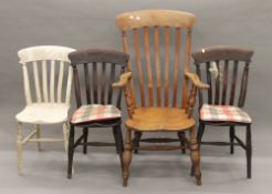 A Victorian elm seated splat back open armchair and three Victorian kitchen chairs.