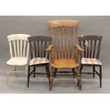 A Victorian elm seated splat back open armchair and three Victorian kitchen chairs.