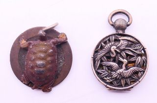 A Chinese silver pendant and a tortoise form pendant. Tortoise pendant 2.5 cm diameter.