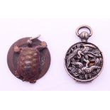 A Chinese silver pendant and a tortoise form pendant. Tortoise pendant 2.5 cm diameter.