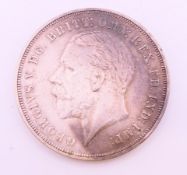 A 1935 George V silver (Rocking Horse) crown coin.