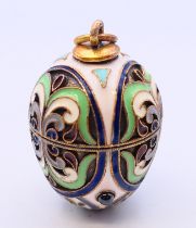 A silver and enamel egg pendant bearing Russian marks. 3 cm high.