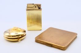 A Kigu vintage compact, an Estee Lauder compact and a Crown musical lighter.