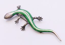 A silver and enamel lizard-form brooch. 9.25 cm long.