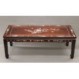 A Chinese mother-of-pearl inlaid hardwood coffee table. 111 cm long.