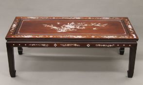 A Chinese mother-of-pearl inlaid hardwood coffee table. 111 cm long.