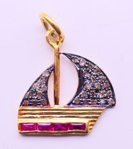 A diamond and ruby charm/pendant in the form of a boat. 2 cm high.
