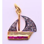 A diamond and ruby charm/pendant in the form of a boat. 2 cm high.