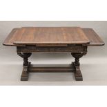 An early 20th century carved oak drawer leaf dining table. 193 cm long extended x 99 cm wide.