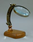 A magnifying glass on a stand. 21 cm high.