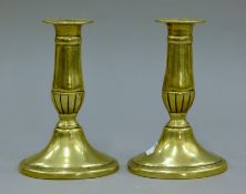 A pair of antique brass candlesticks. 15 cm high.