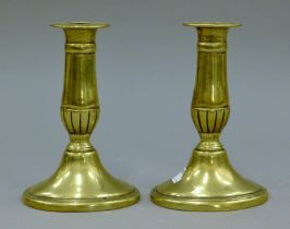 A pair of antique brass candlesticks. 15 cm high.