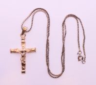 A silver crucifix on a silver chain.