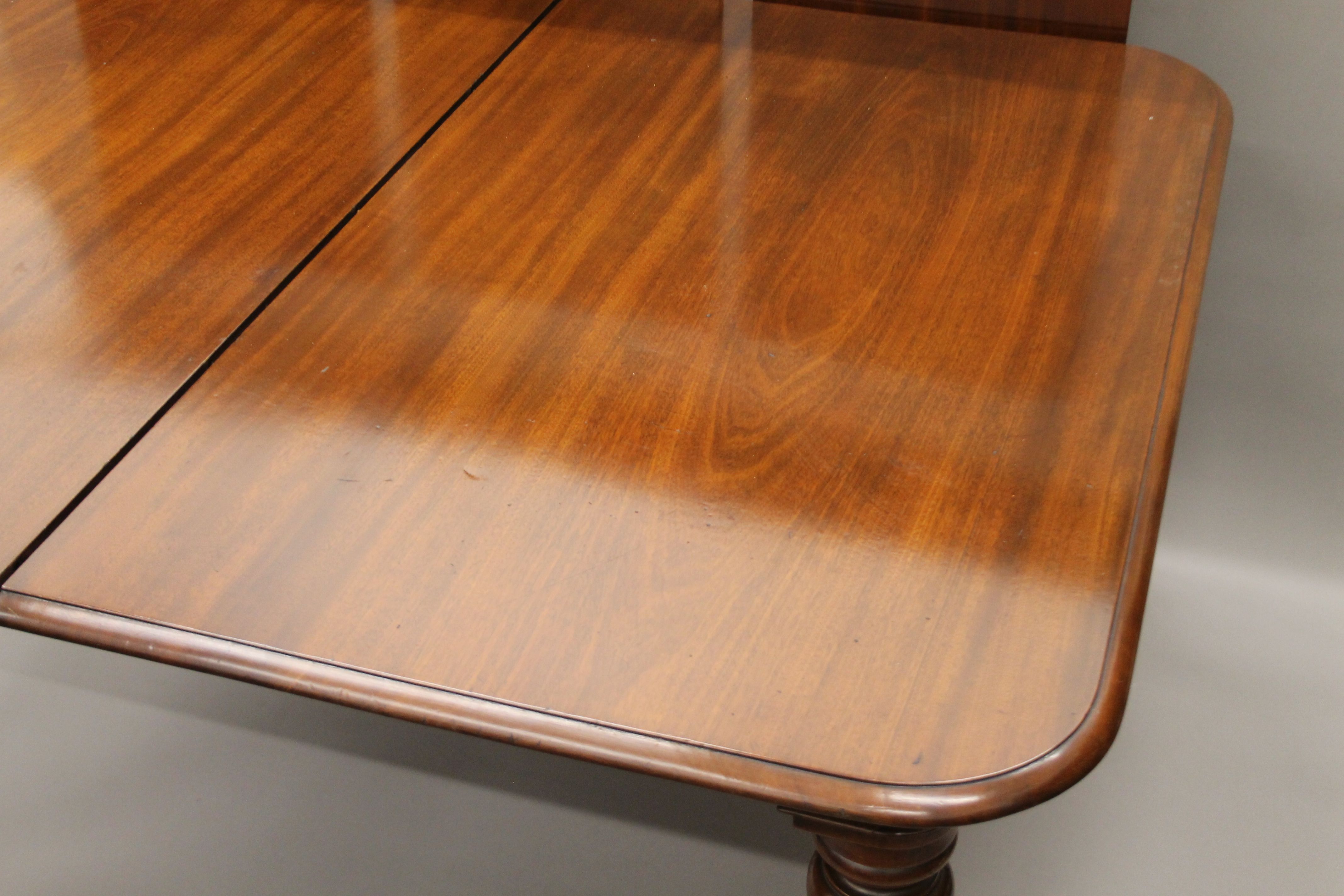 A 19th century mahogany three-leaf extending dining table. - Image 2 of 5