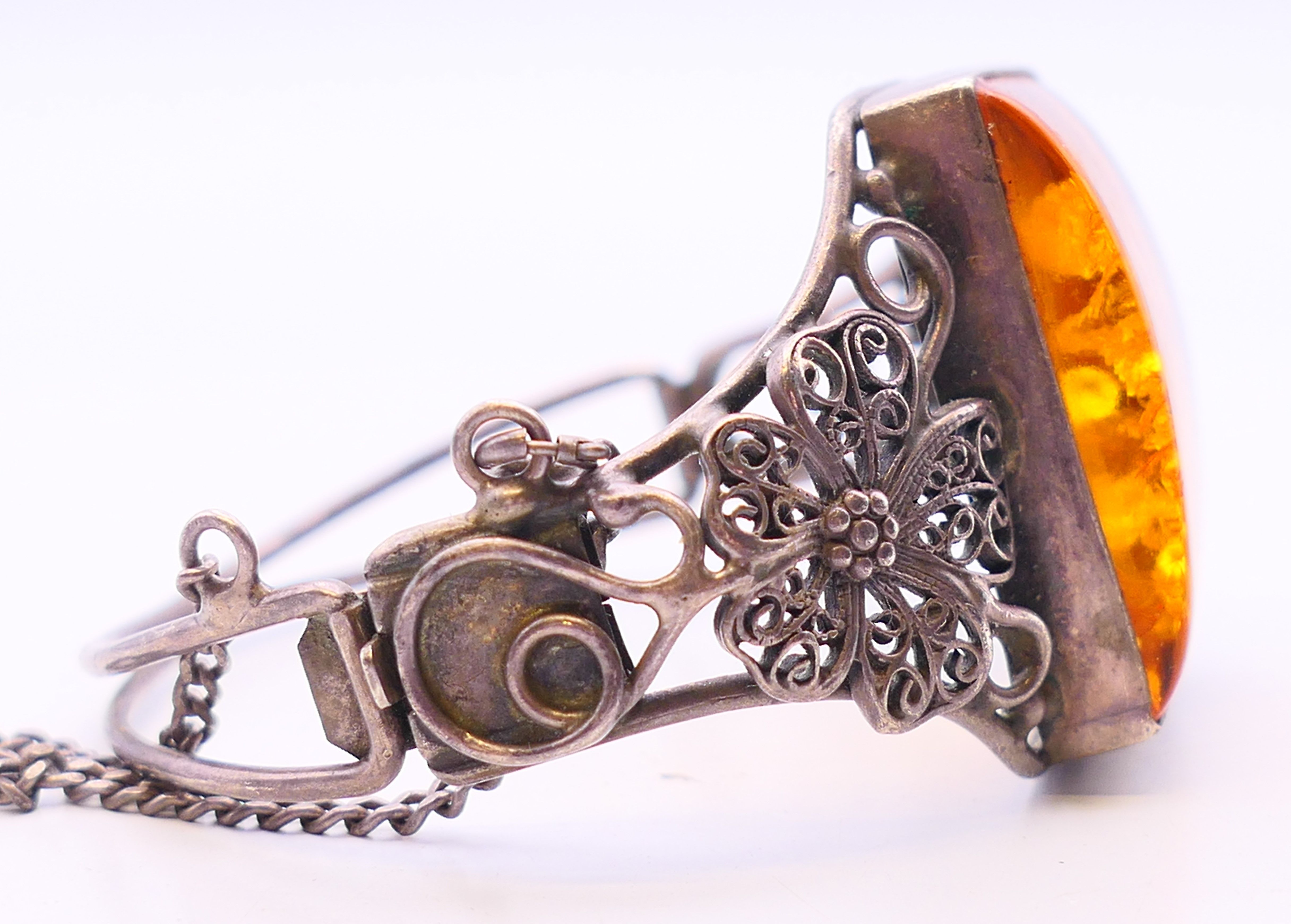 An "amber" white metal (tested silver) bracelet. 6 cm diameter. - Image 3 of 5
