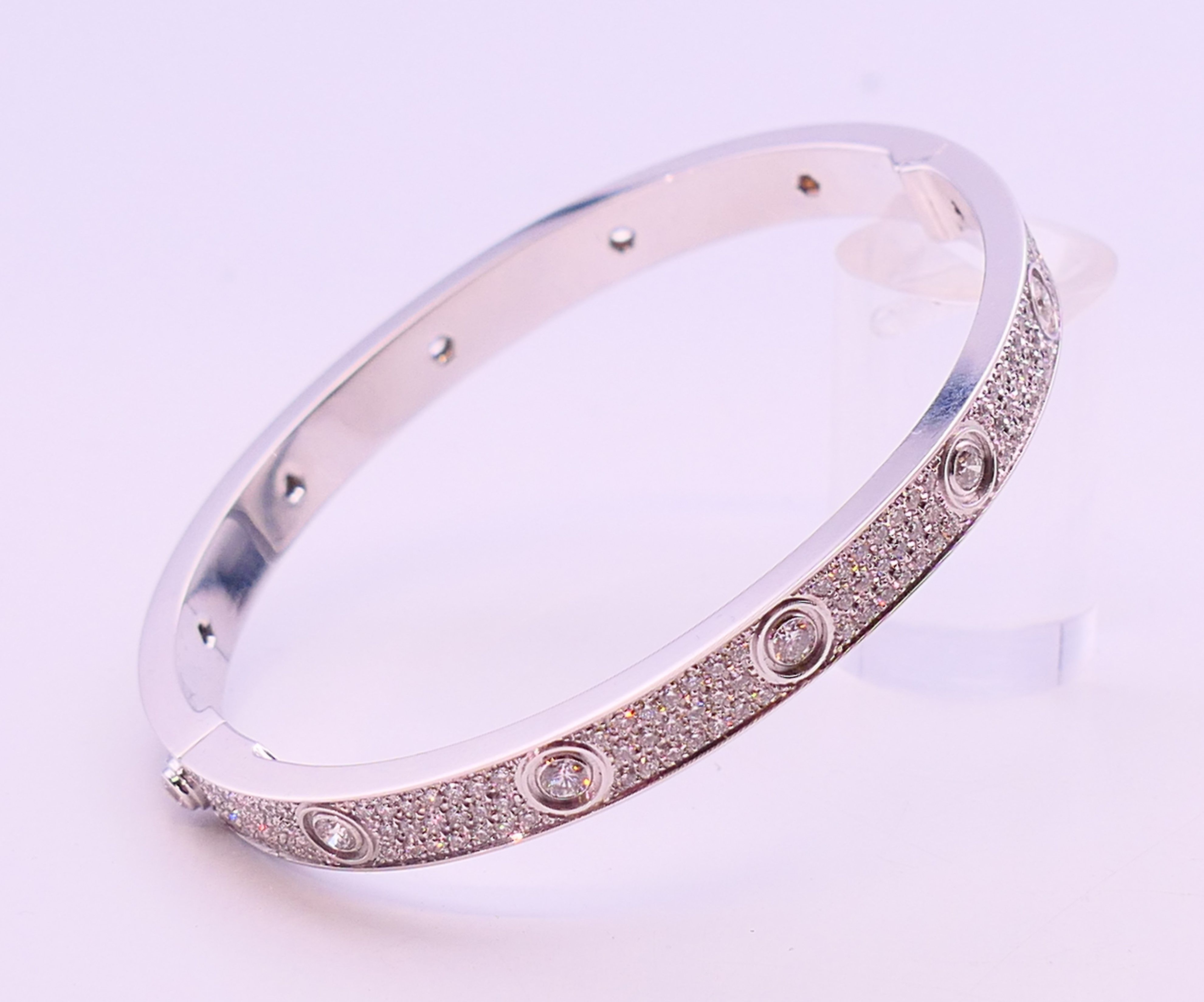 A Cartier 18 K white gold and diamond encrusted love bangle numbered 19 PDR729. 6. - Image 6 of 13