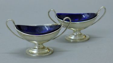 A pair of Victorian oval salts and liners, hallmarked for London 1886. 10.5 cm wide. 93.8 grammes.