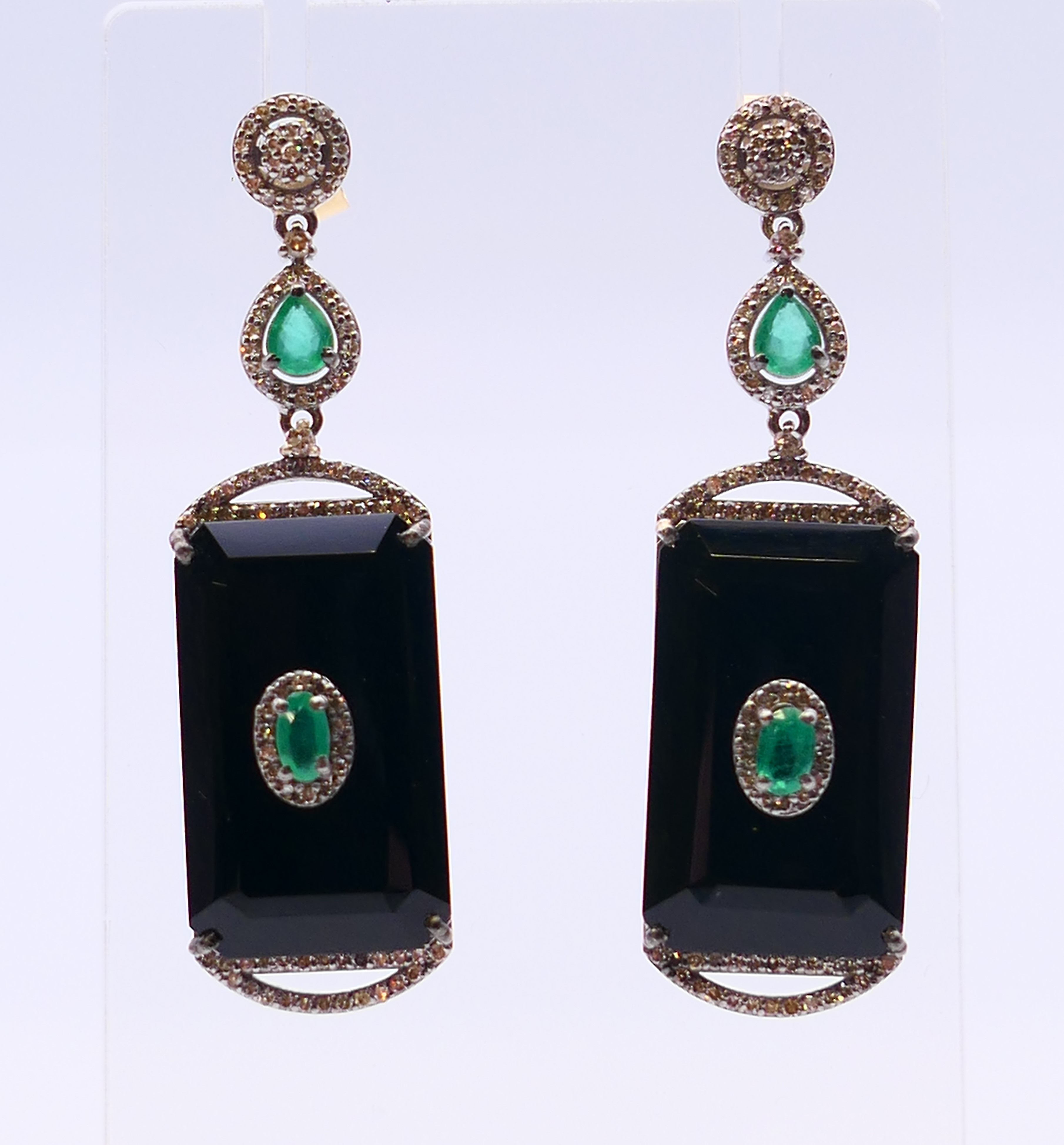 A pair of onyx, diamond and emerald earrings. 5.5 cm high.