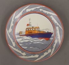 A Poole Pottery dish decorated with a lifeboat in an associated Poole Pottery box. 26.5 cm diameter.