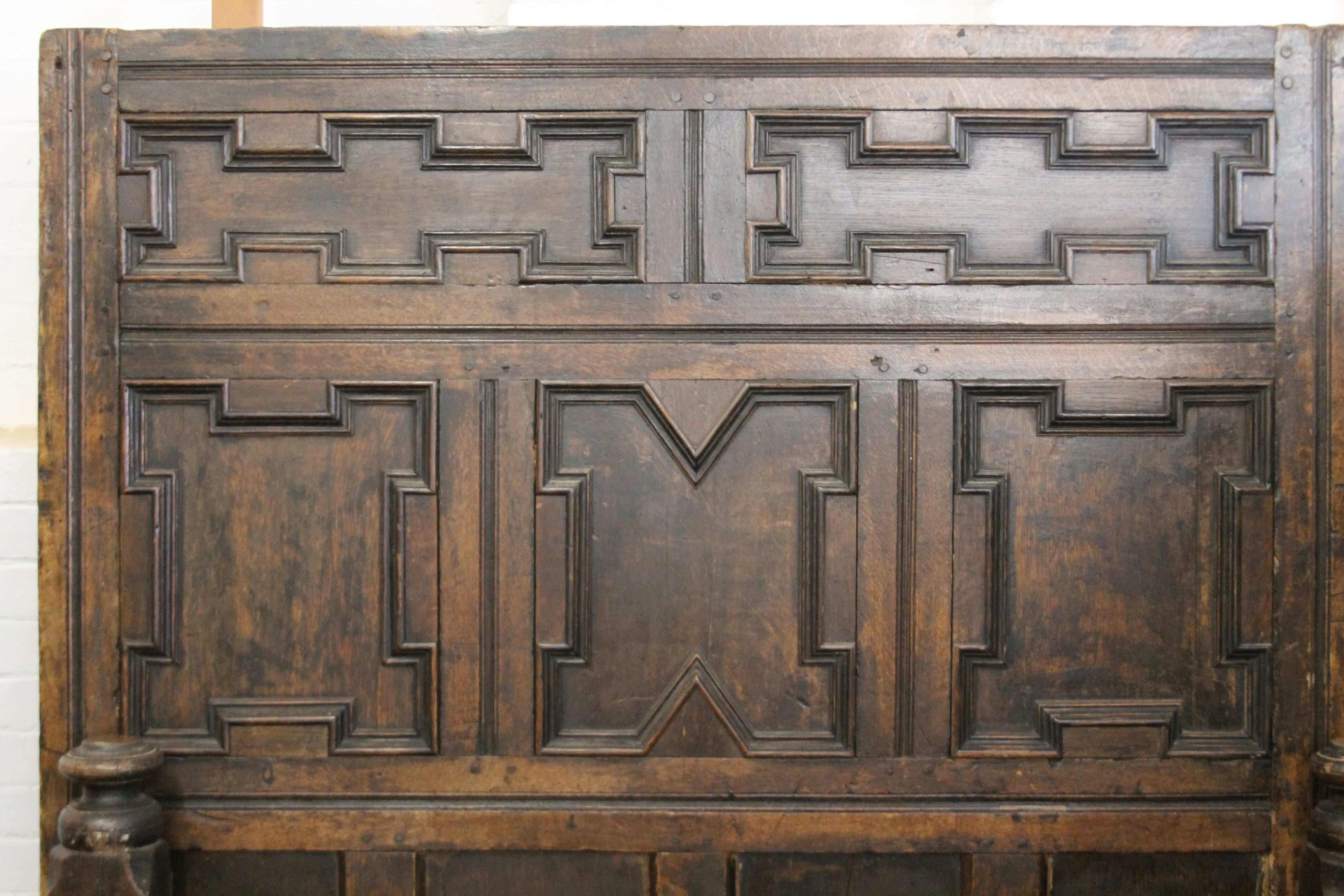 A 17th/18th century carved oak bed. 135 cm wide x 182 cm high. - Image 2 of 6