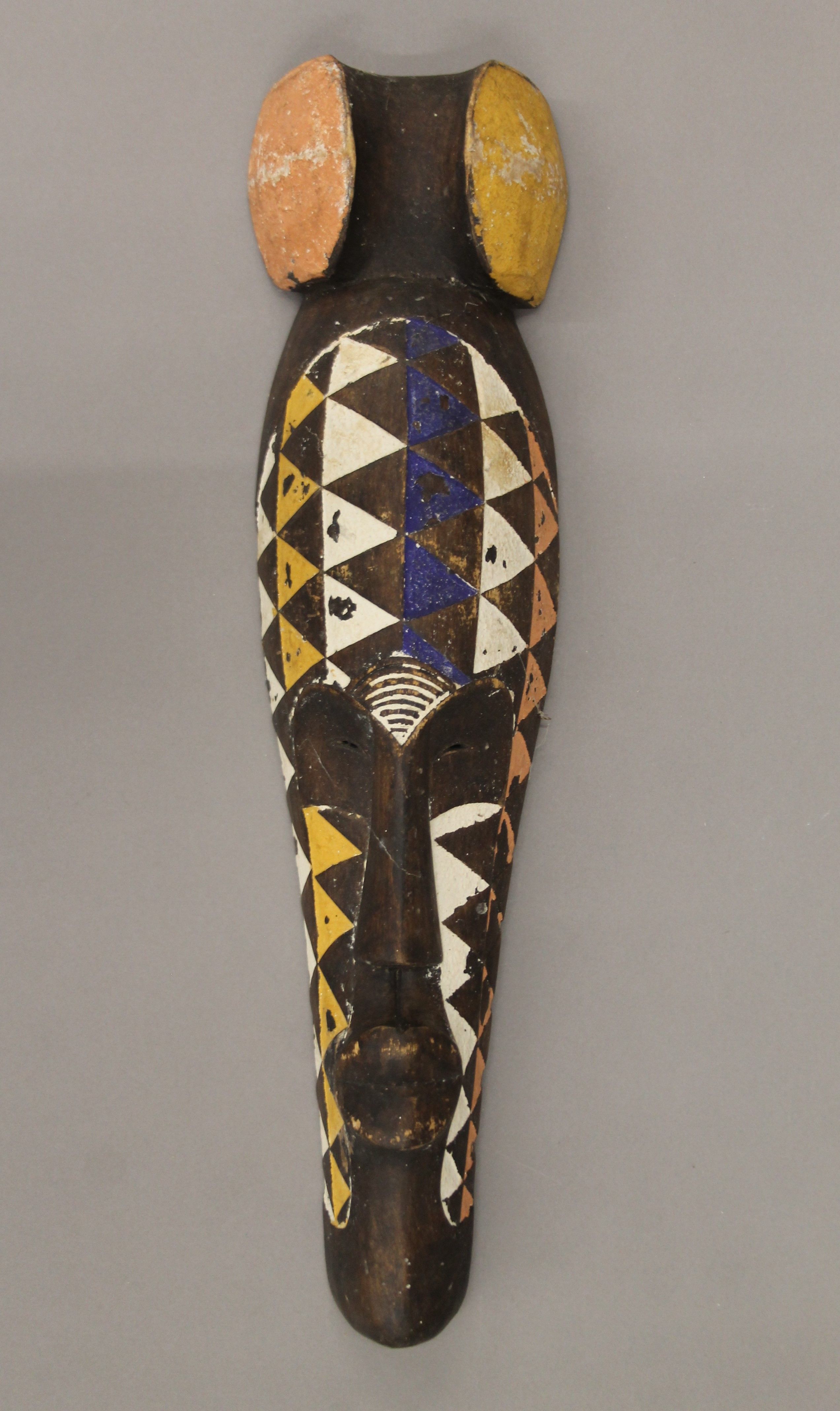 An African painted wooden tribal mask. 53 cm high. - Image 2 of 4