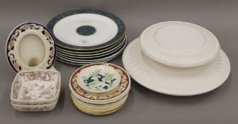 A quantity of Royal Doulton and Royal Worcester and Aynsley plates at different stages of the