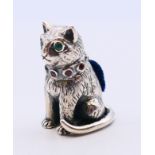 A silver pin cushion in the form of a cat. 3 cm high.