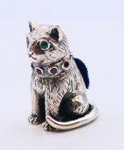 A silver pin cushion in the form of a cat. 3 cm high.