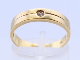 A 14 ct gold and diamond band ring. Ring size O/P.
