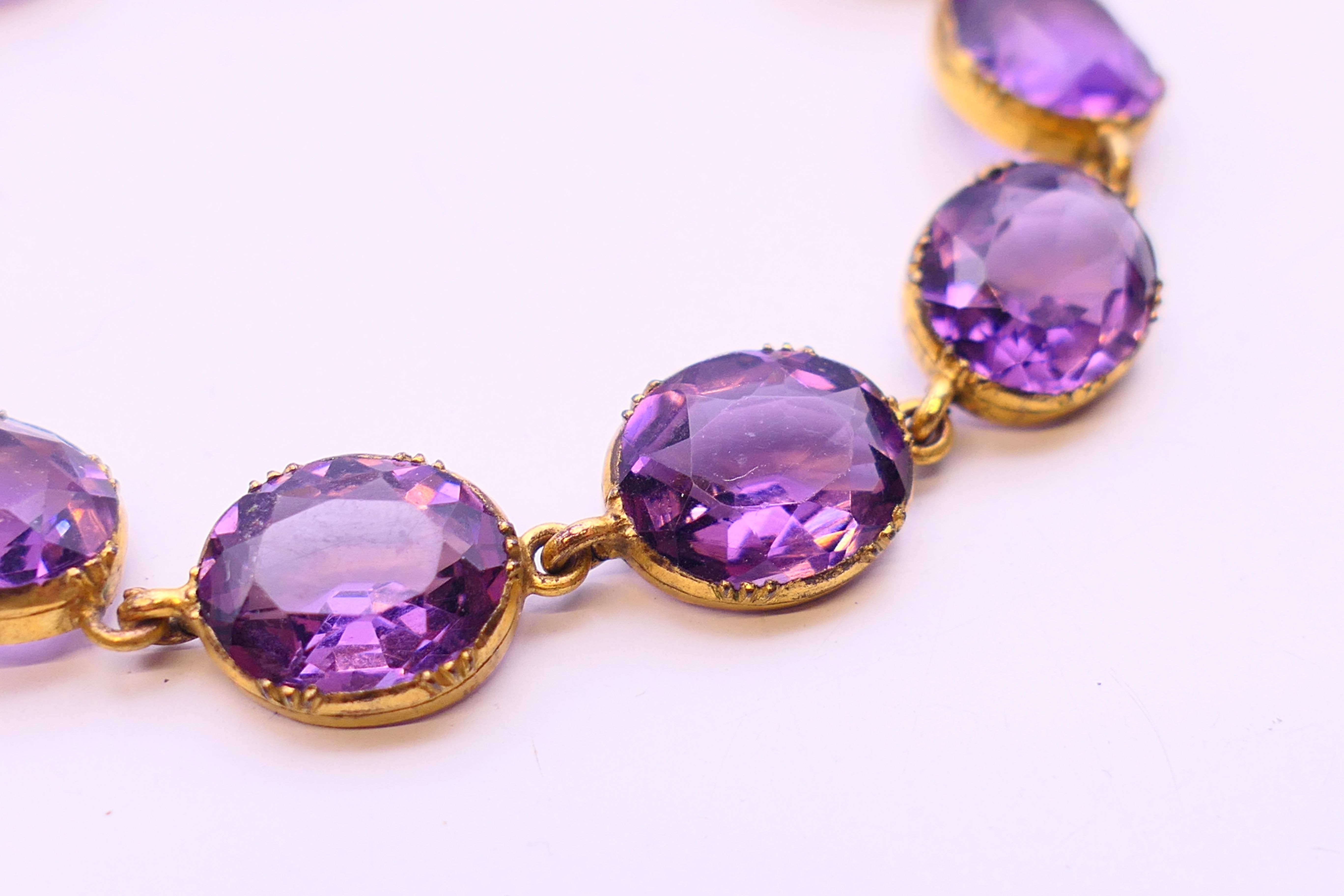Two Edwardian pendant necklaces, one on a 9 ct gold chain, and a gilt metal and amethyst bracelet. - Image 3 of 14