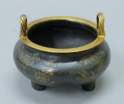 A Chinese silver inlaid guilt-topped bronze censer. 13 cm wide.