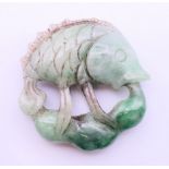 A jade carving of a fish. 5.5 cm diameter.